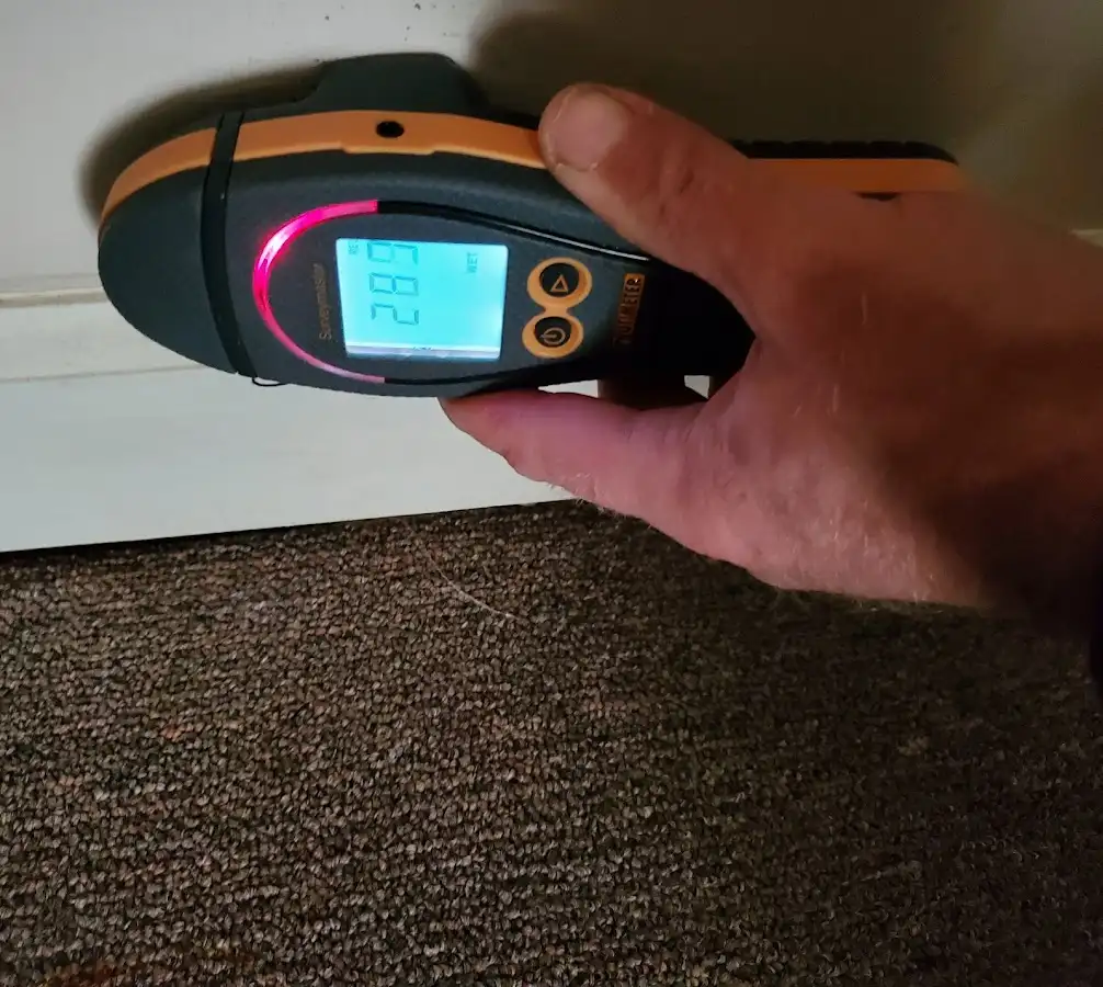 Moisture detection at baseboard during Storm Damage Restoration in Roy